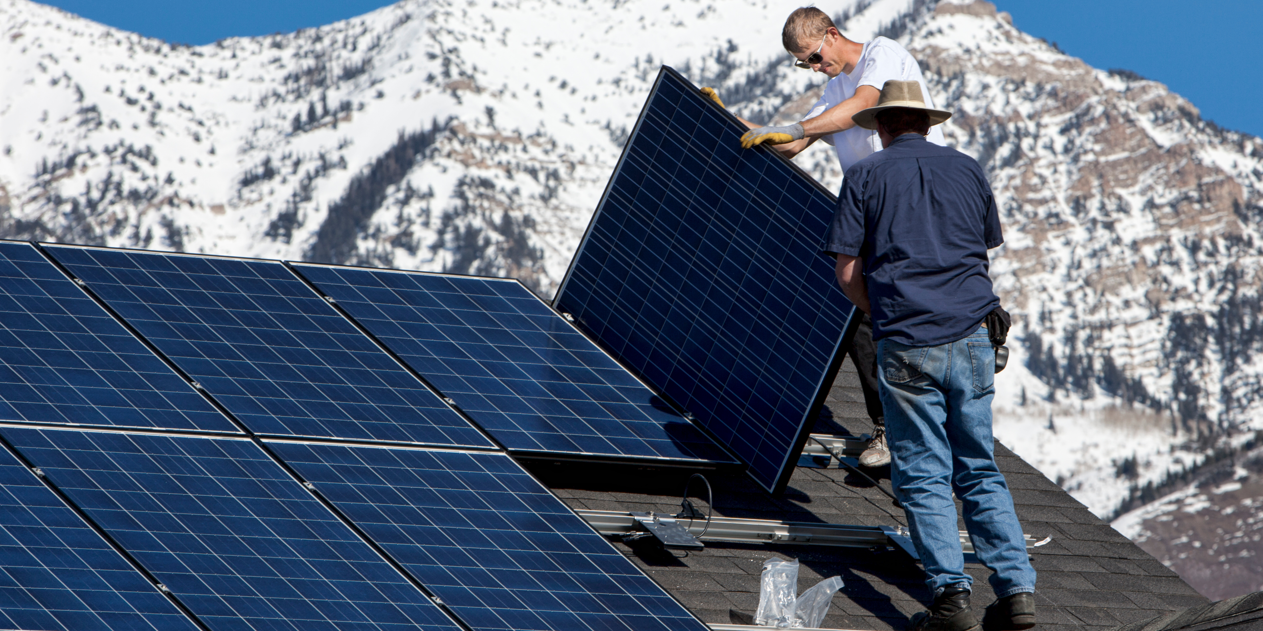 Solar Installers Installing Panels on a Rooftop